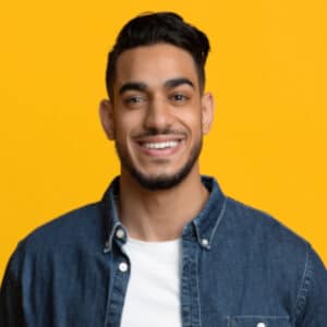 Smiling middle eastern man in casual with laptop y9ey47v
